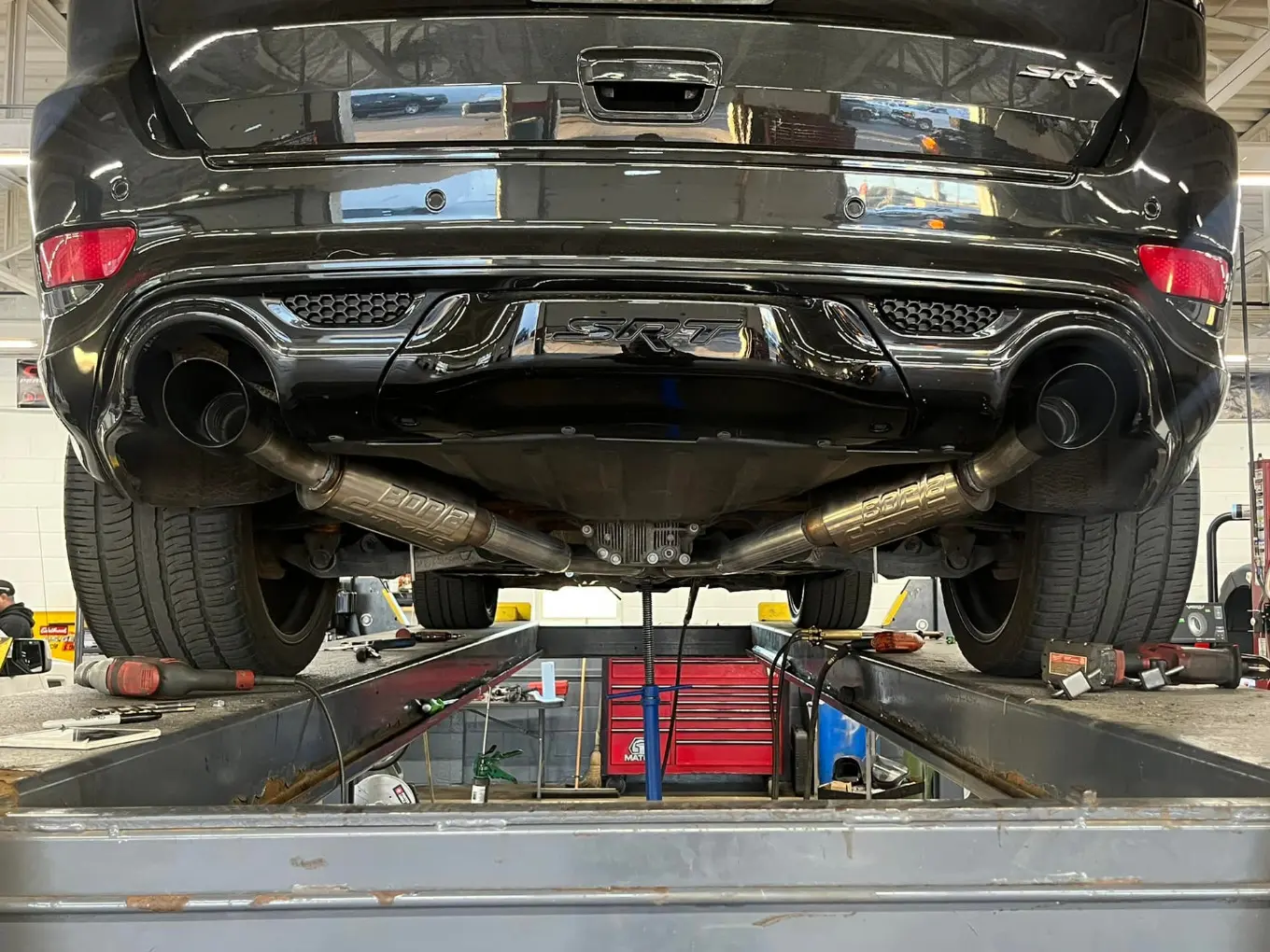 Black SRT Vehicle on Lift with Visible Exhaust System